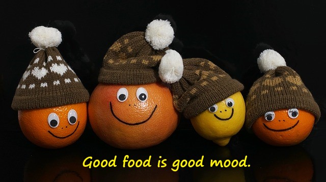 Good Food is Good mood quote for mental health on pic with oranges wearing hats