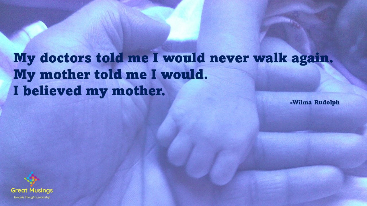 Motherly Quote on image of parent child hands.